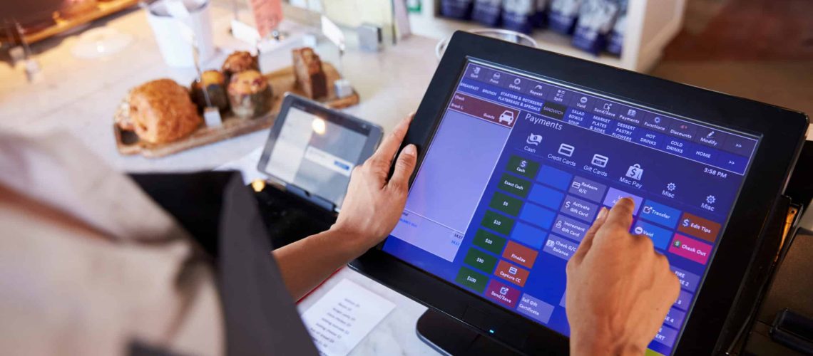 Close Up Of Female Employee Working At Delicatessen Checkout