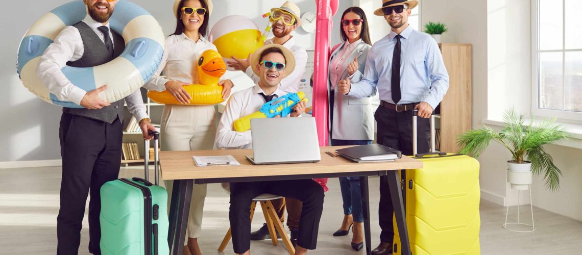 Working in office, business coworkers transition from work to vacation mode, with inflatable rings and suitcases. The team eagerly anticipates a holiday full of beach vibes and summer adventures.